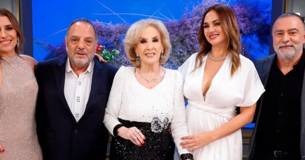 Pantallas de televisión mostrando los logos de Gran Hermano y La noche de Mirtha con gráficos de audiencia.