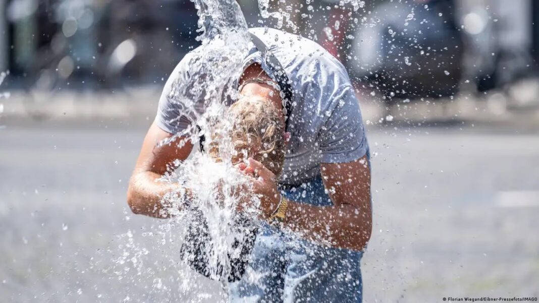 Personas en una fuente pública durante una ola de calor en Europa