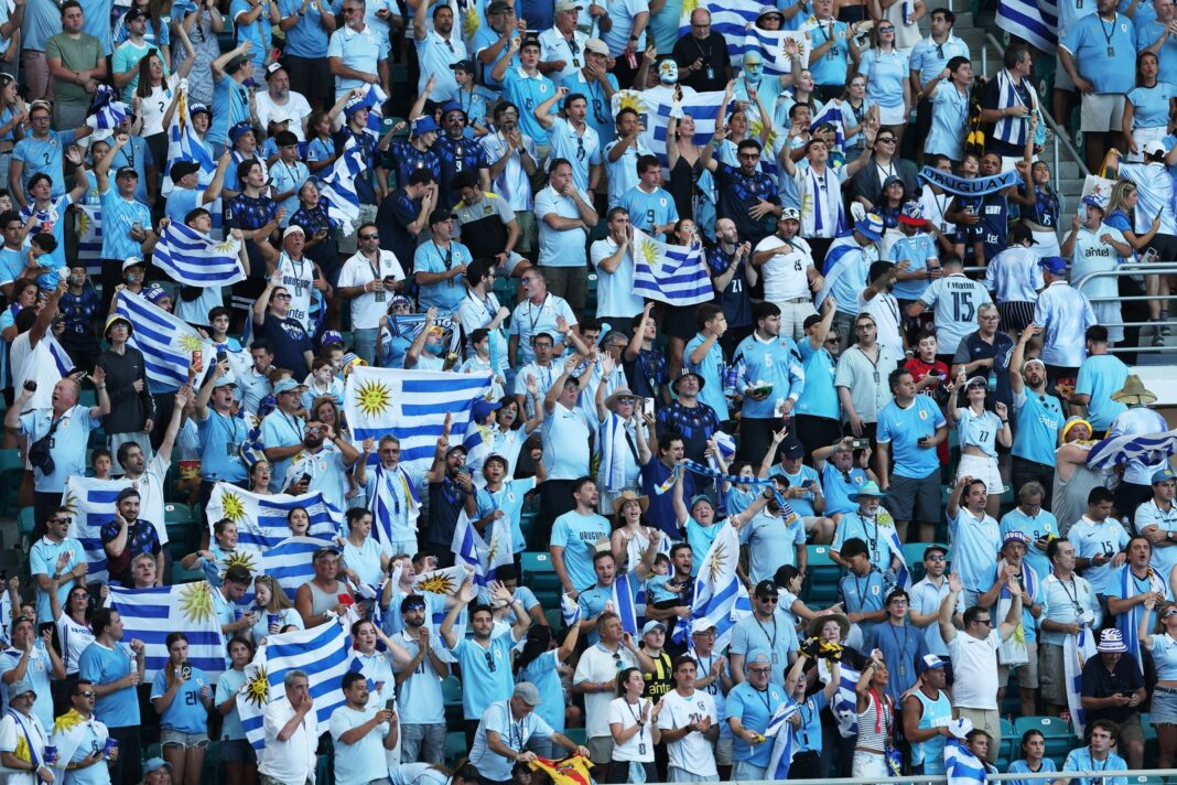 Aficionados uruguayos con banderas celestes en la Plaza de Armas de Guadalajara